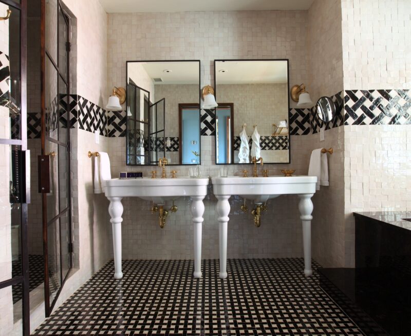 The North Moore Duplex Master bathroom with double white vanities and iris, walk-show and custom two tone and white tile