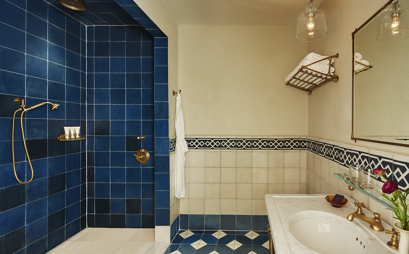 Superior King room shower, blue and white tile and sink at The Greenwich Hotel