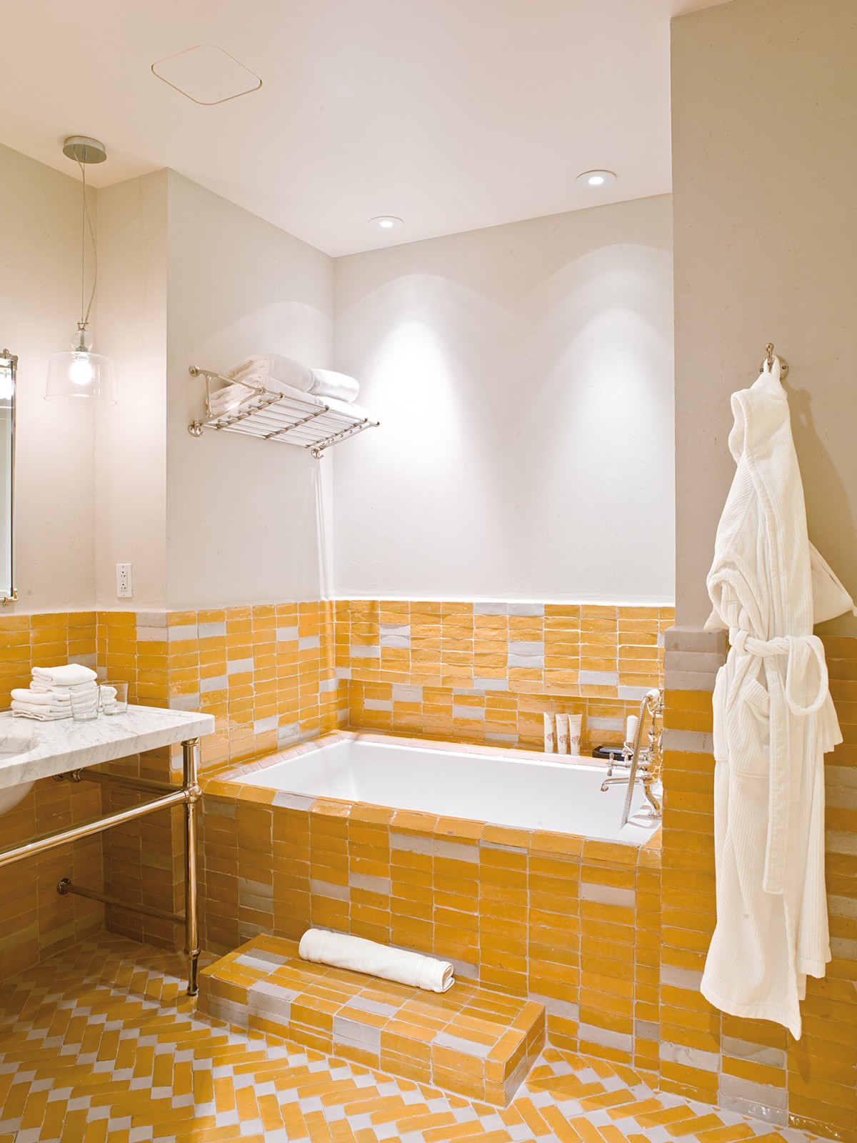 Yellow patterned bathroom tile details in the Courtyard Queen with Soaking Tub Room