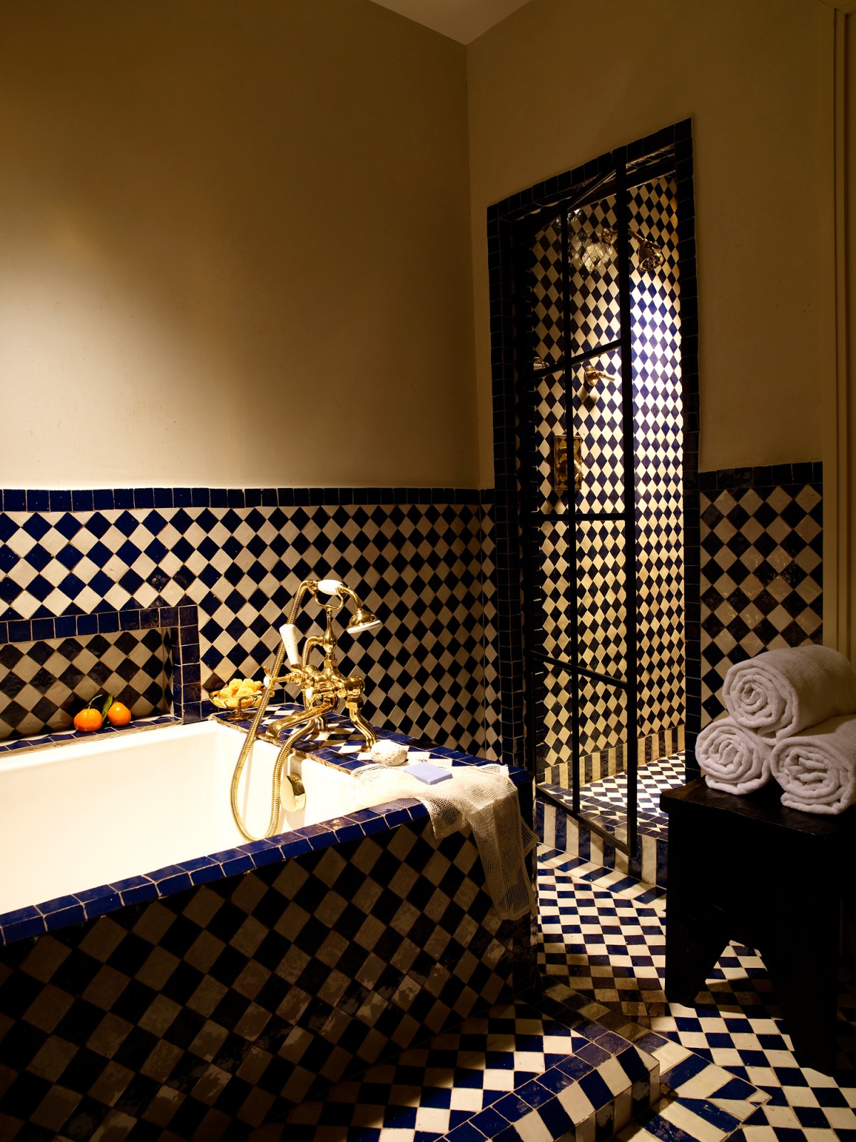 View of the tub, shower and patterned tile in the Deluxe King room