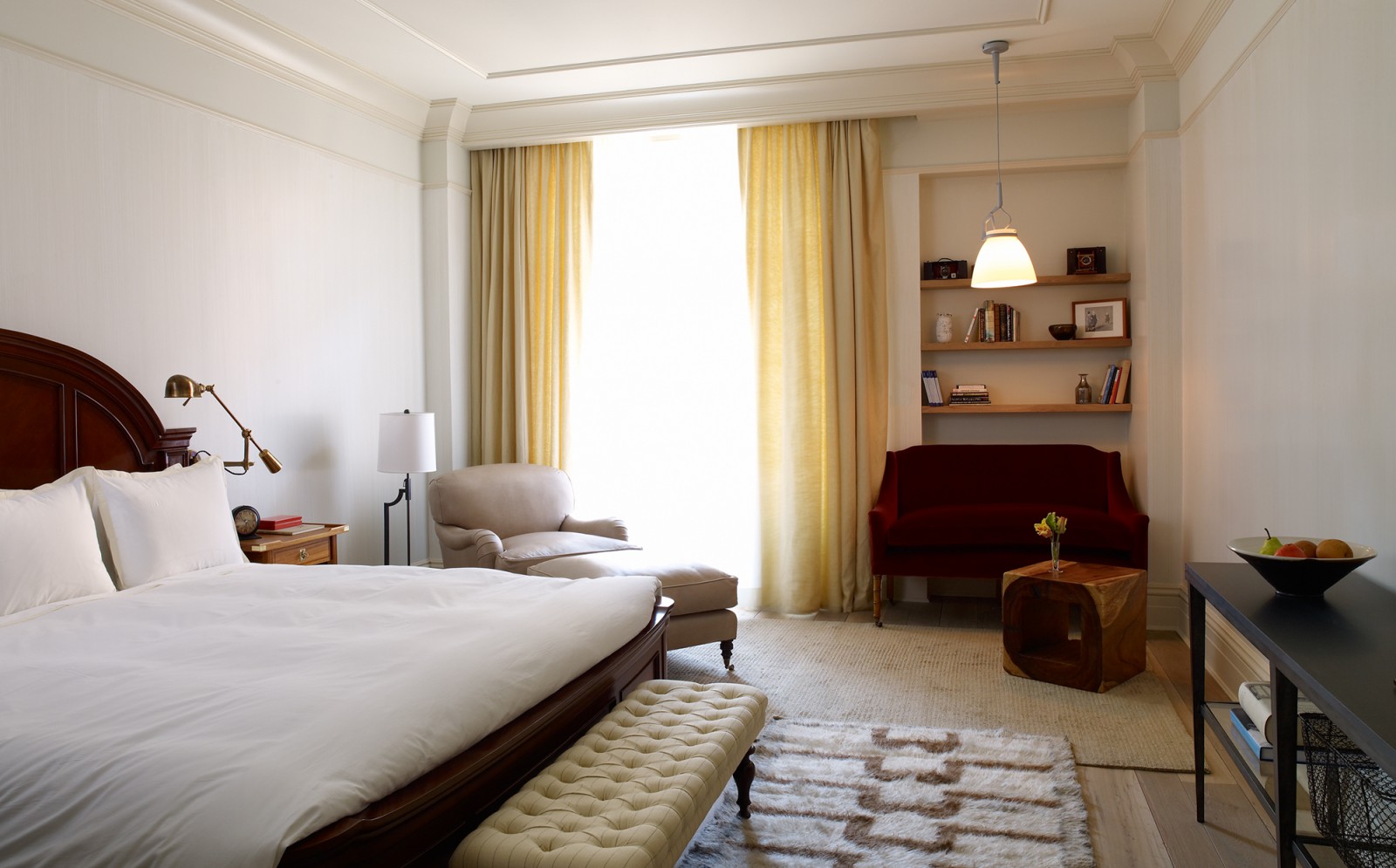 View of the bed, seating and desk in the Deluxe King Room