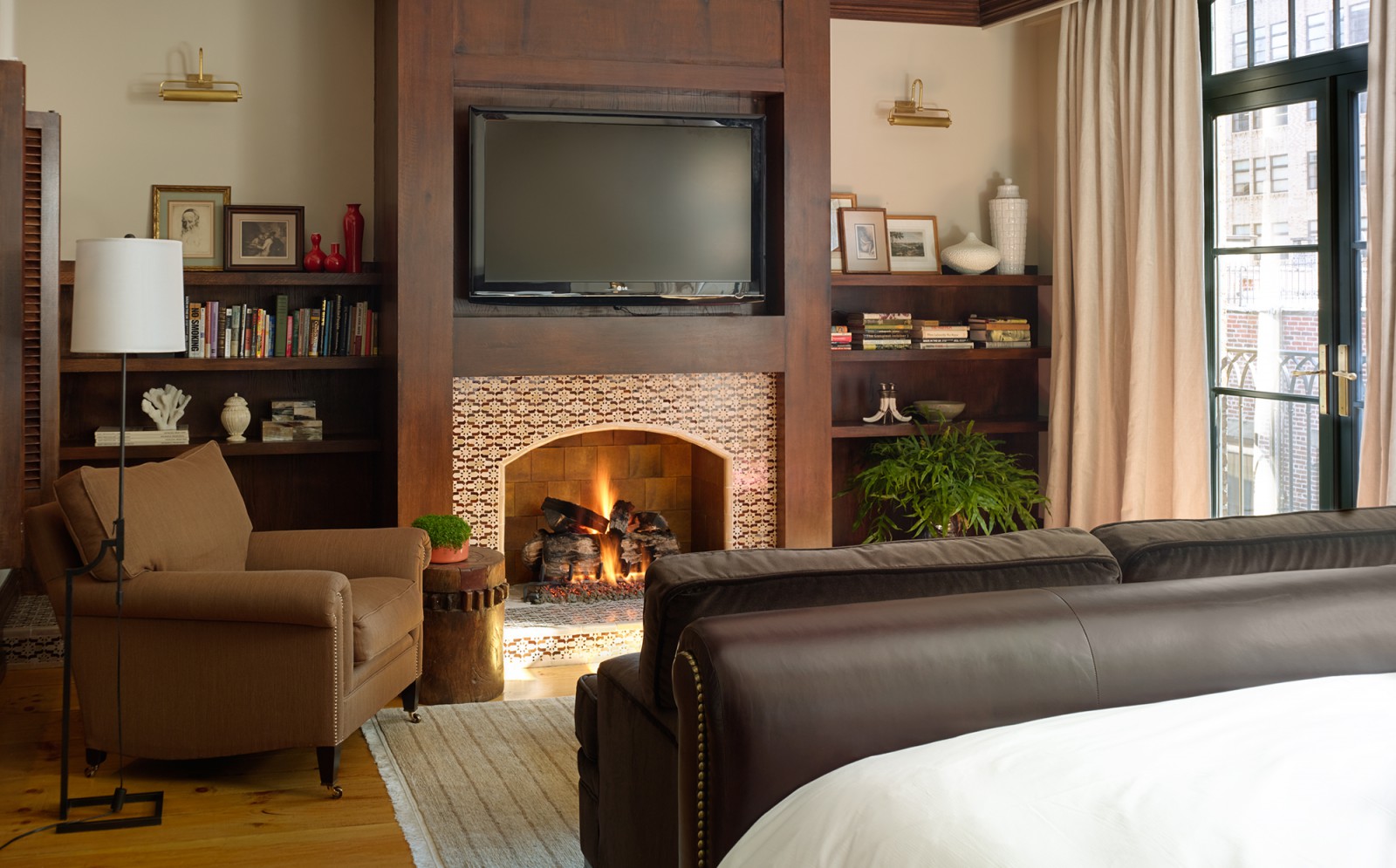 Detail of the bedroom fireplace and seating area in the N. Moore Penthouse at the Greenwich Hotel