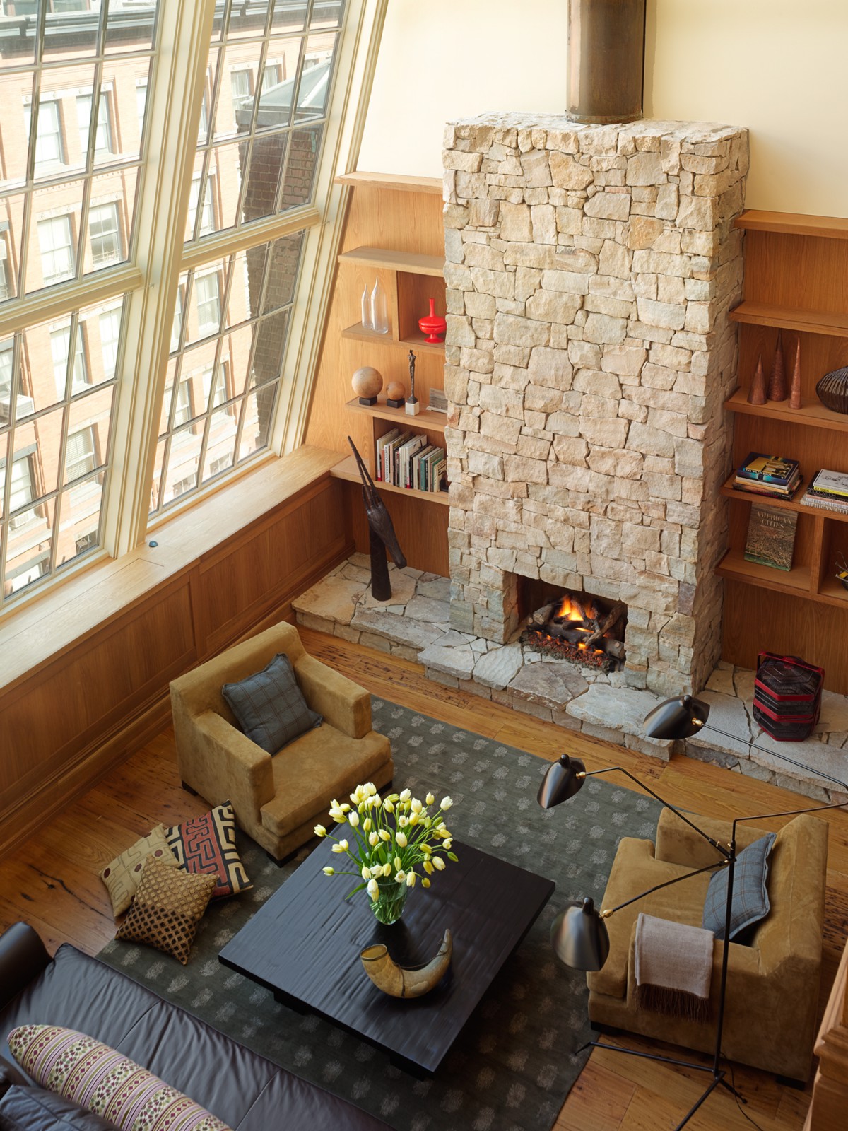 Overhead view of the living area, large windows and fireplace in the N. Moore Penthouse
