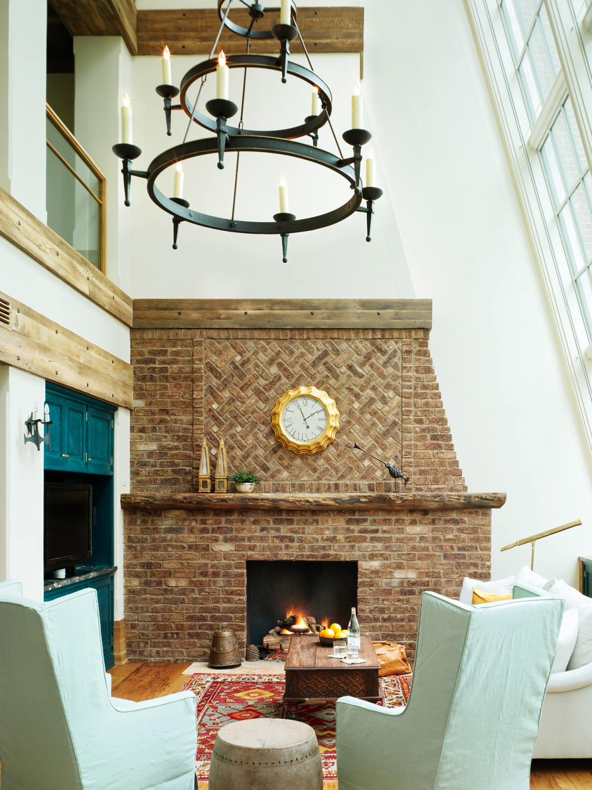 Detail of chandelier, large window and living space in the Greenwich Penthouse