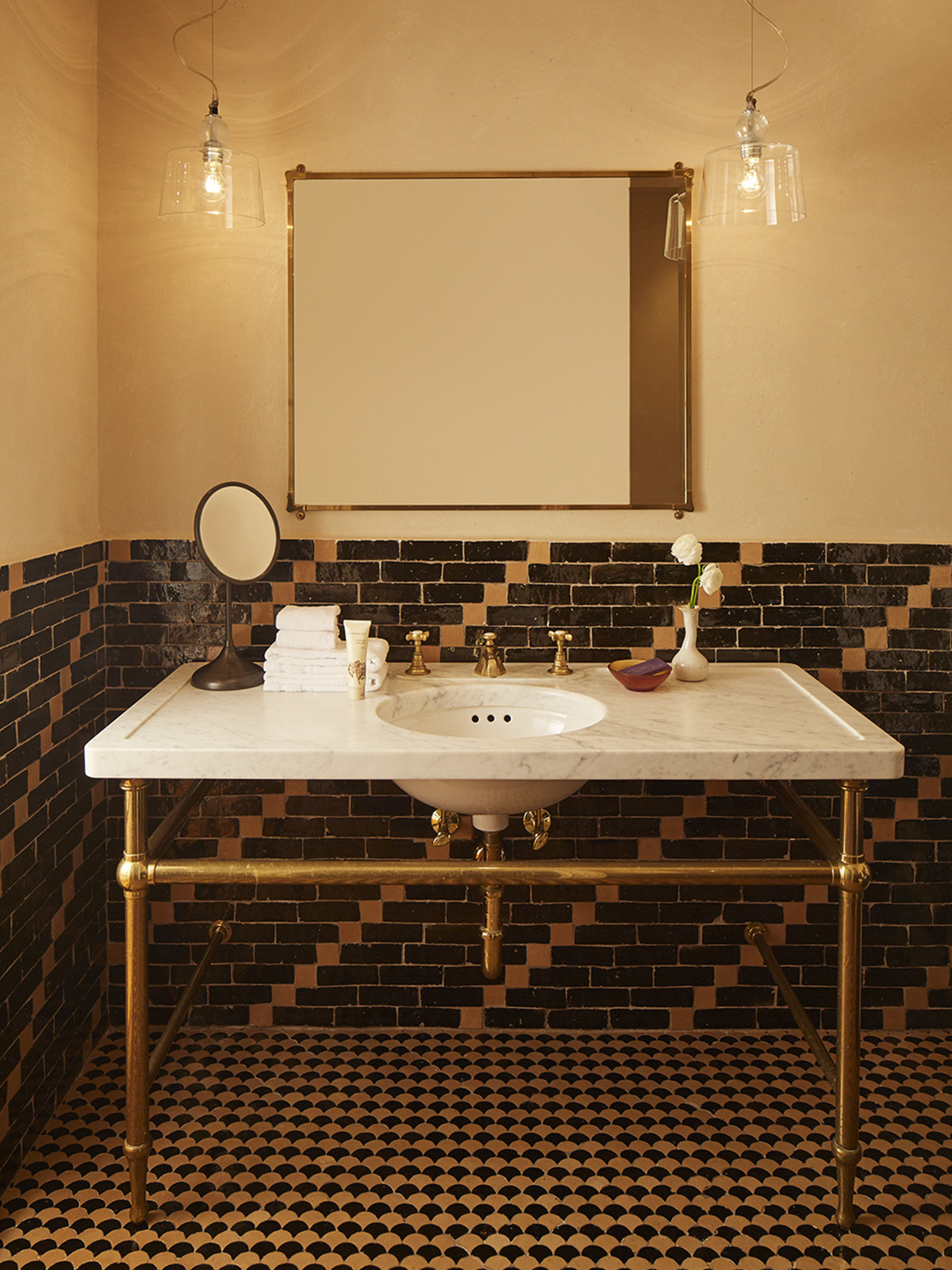 View of the bathroom sink and patterned tile in the Superior King room