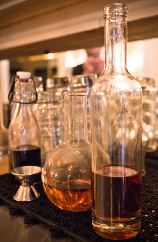 View of various house liqueurs at Weather Up Cocktail Bar