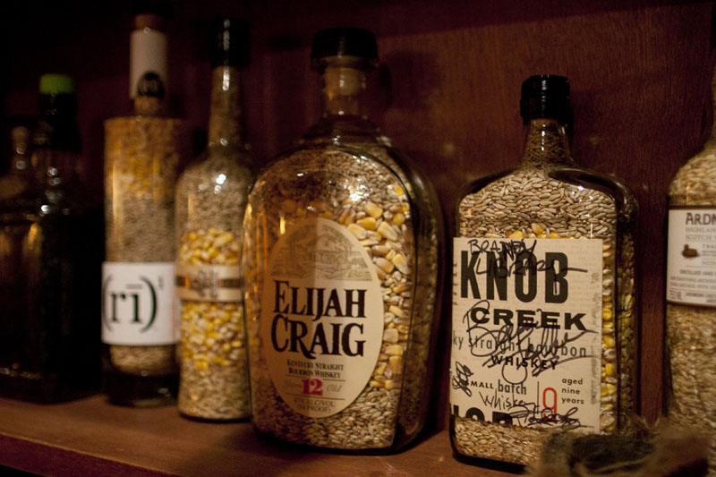 Empty bottles filled with corn and grain inside the Brandy Library