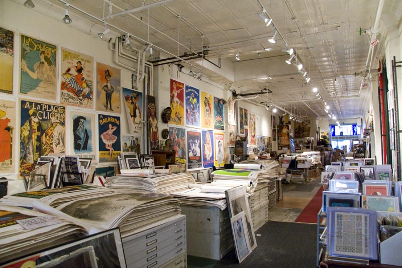 A view of the long showroom, covered walls and flatfiles inside Philip Williams Posters