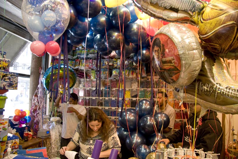 A Balloon Saloon staff member working behind the counter