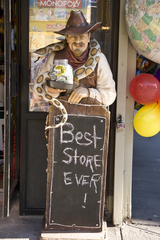 Door sign featuring Man with a snake at the Balloon Saloon