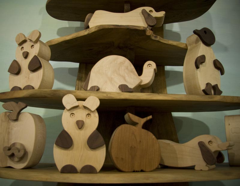 Display of wooden animal figurines for sale Playing Mantis Toys and Crafts