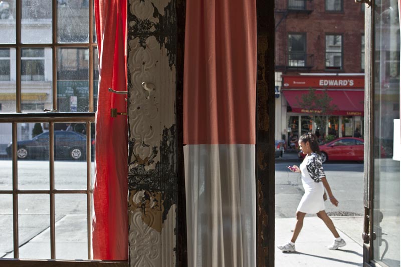 Looking out at the street through a window and open door at Tiny's and the Bar Upstairs