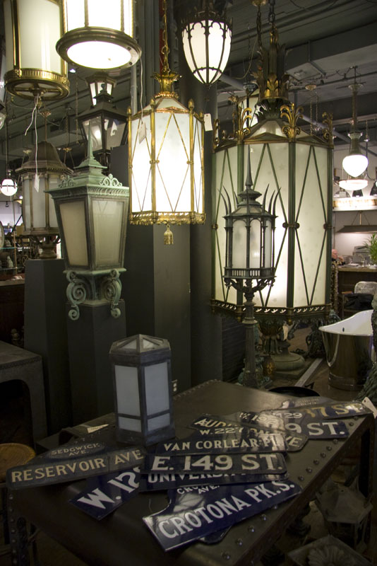 Various lanterns and street signs on display inside Urban Archaeology Antiques and Vintage