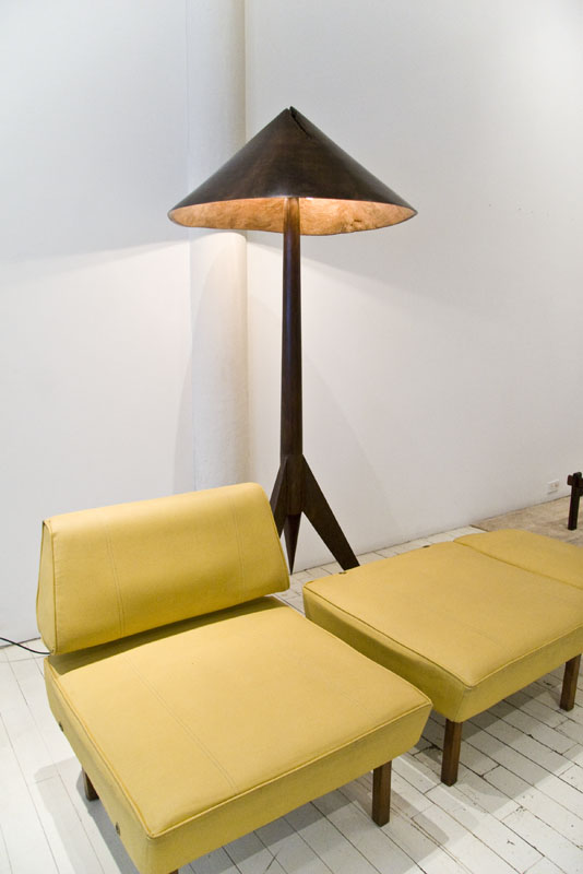 Yellow chair and ottoman and wooden lamp at Espasso