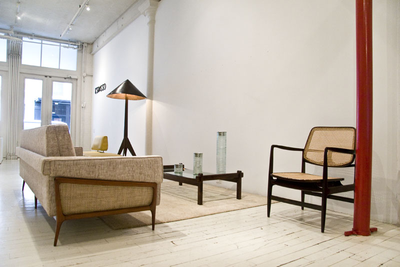 A sofa with wood frame and wooden arm chair at Espasso