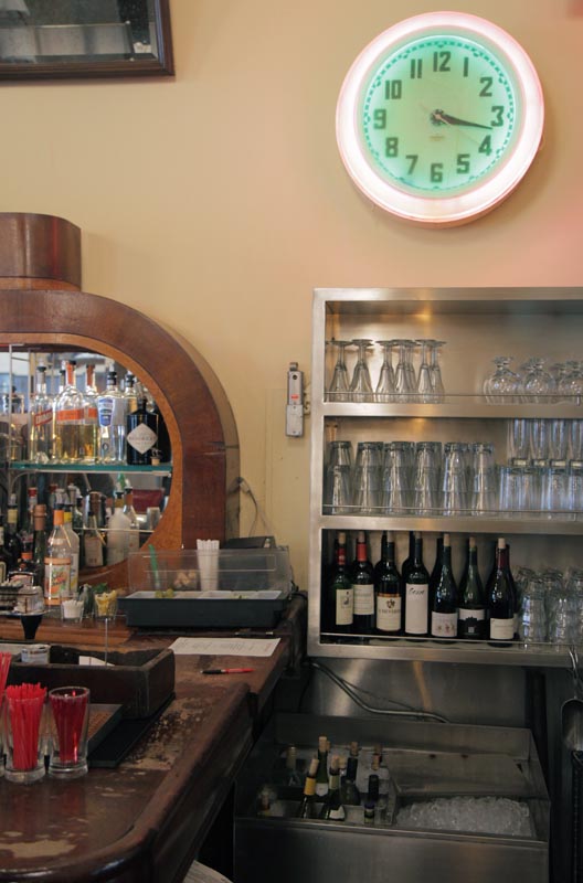 Old neon clock, back bar and drink station at The Odeon