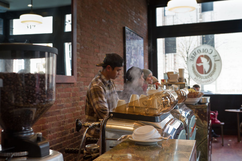 Barista making an espresso drink at La Colombe Coffee