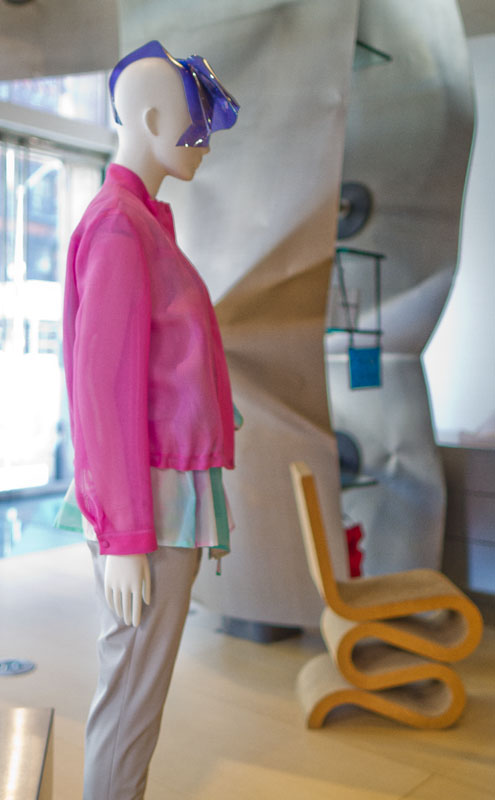 Mannequin in a pink coat inside the store. Shop at Issey Miyake when you stay at The Greenwich Hotel