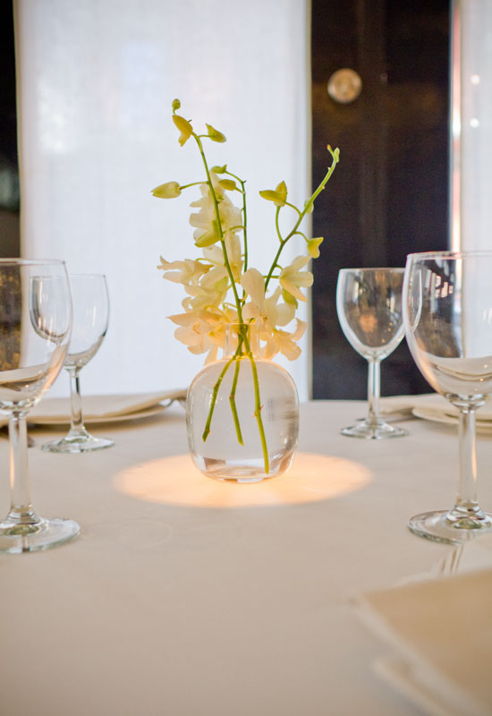 Wine glasses and a small floral center arrangement on the table at Mr Chow