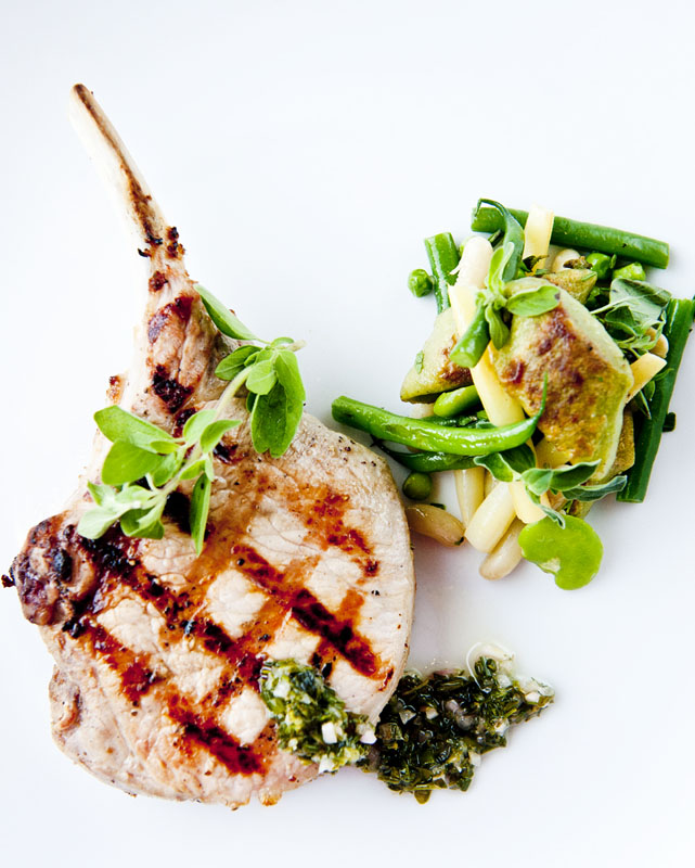 A grilled pork chop dish from The Tribeca Grill located close to The Greenwich Hotel