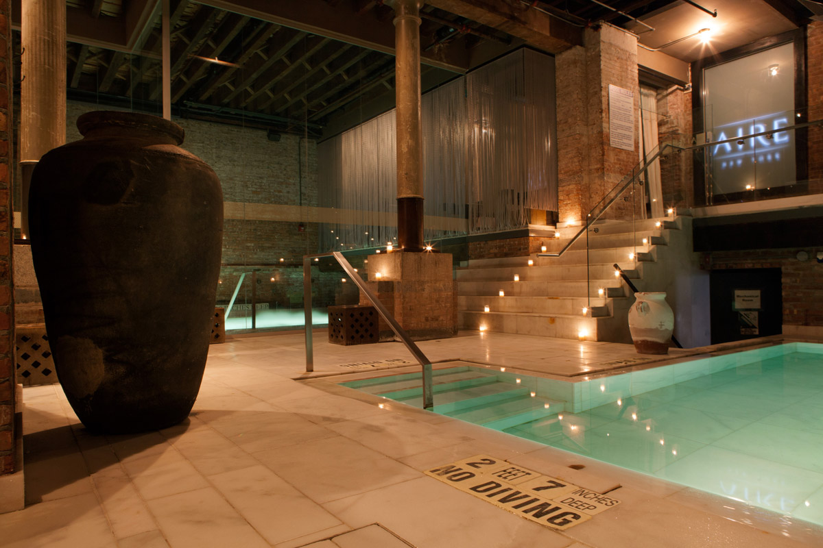 candle lit stairs leading down to a bath