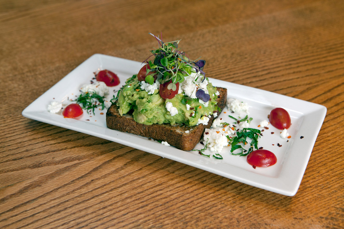 Avocado toast on a white plate at Gotan