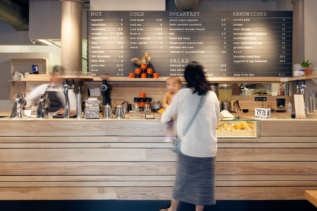 A customer watches the barista make a drink at Gotan