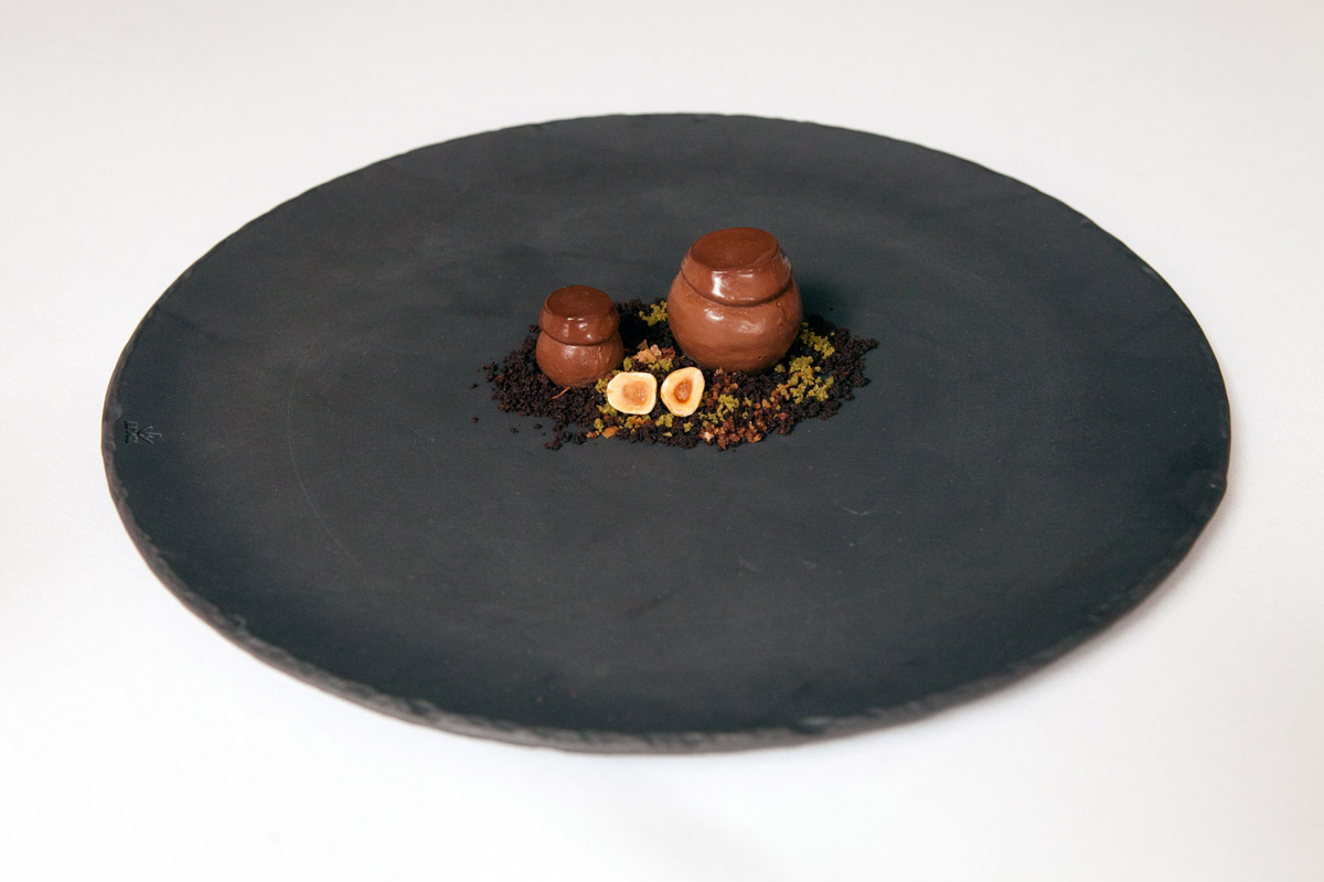 An earthy dessert plated on a dark dish at Jungsik