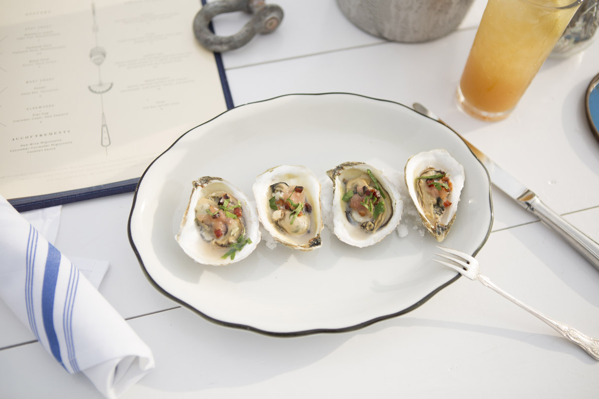 A plate of fresh oysters and table setting