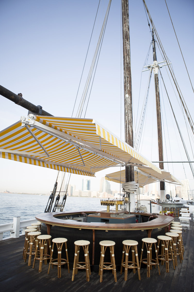 A striped yellow canopy suspended above a circular bar on the Grand Banks