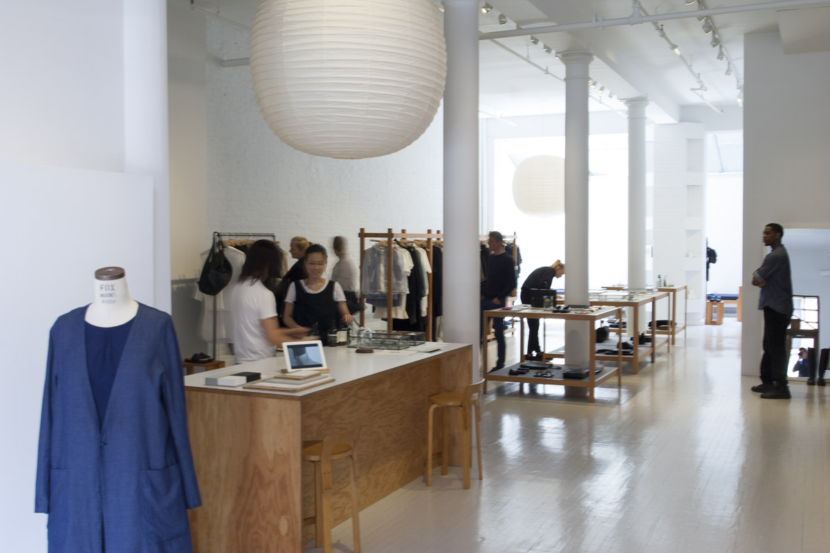 The customer service bar and tall white columns inside the boutique