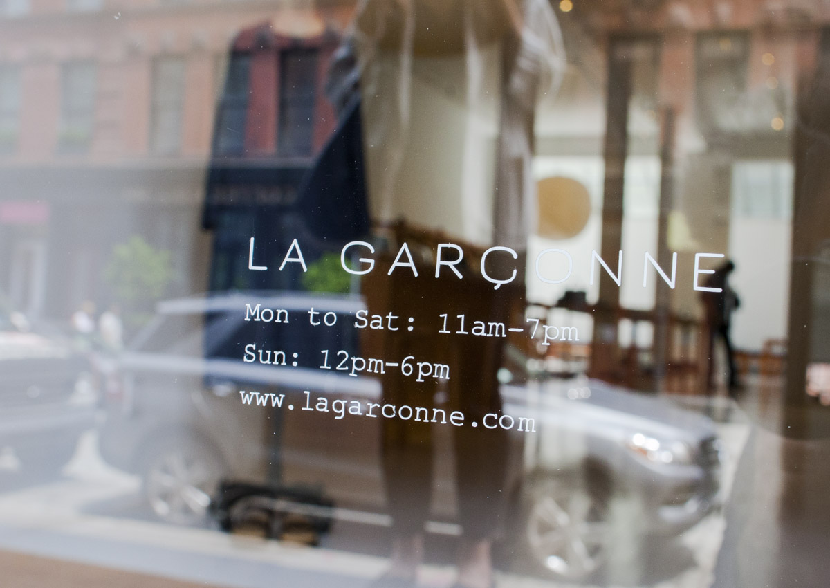 La Garconne window logo and hours