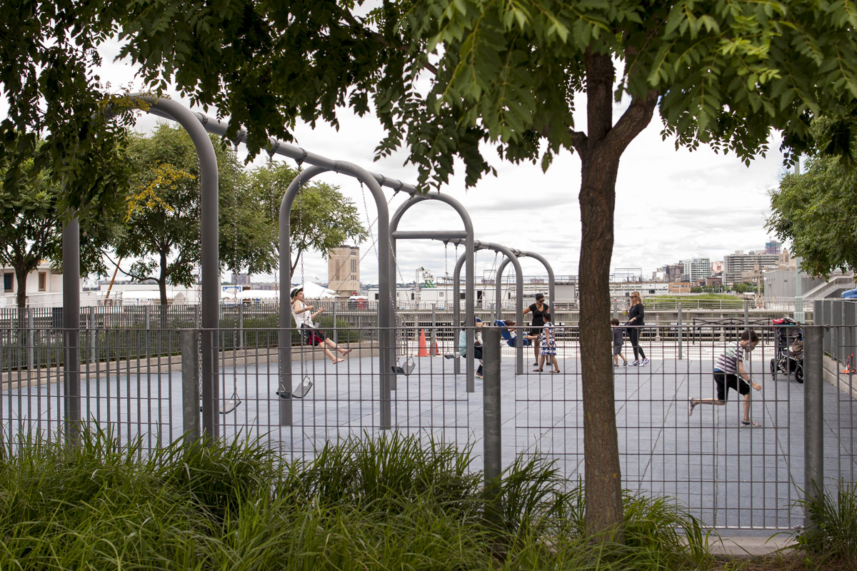 Parents and kids enjoy the swings at Pier 25