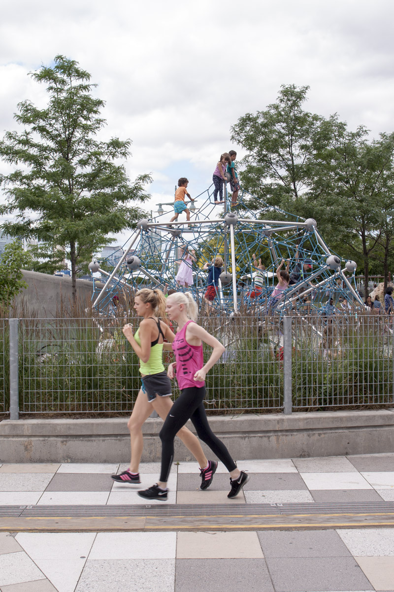 Women run past the kids climbing gym