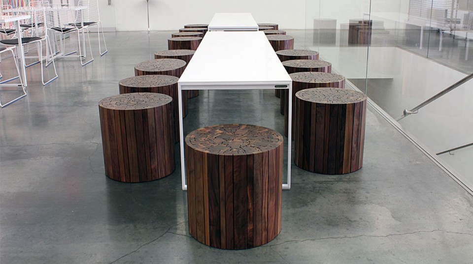 Round Pillar Wood Seating and White Table inside Uhuru