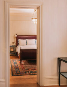 Looking into the bedroom through the doorway in the Corner Suite