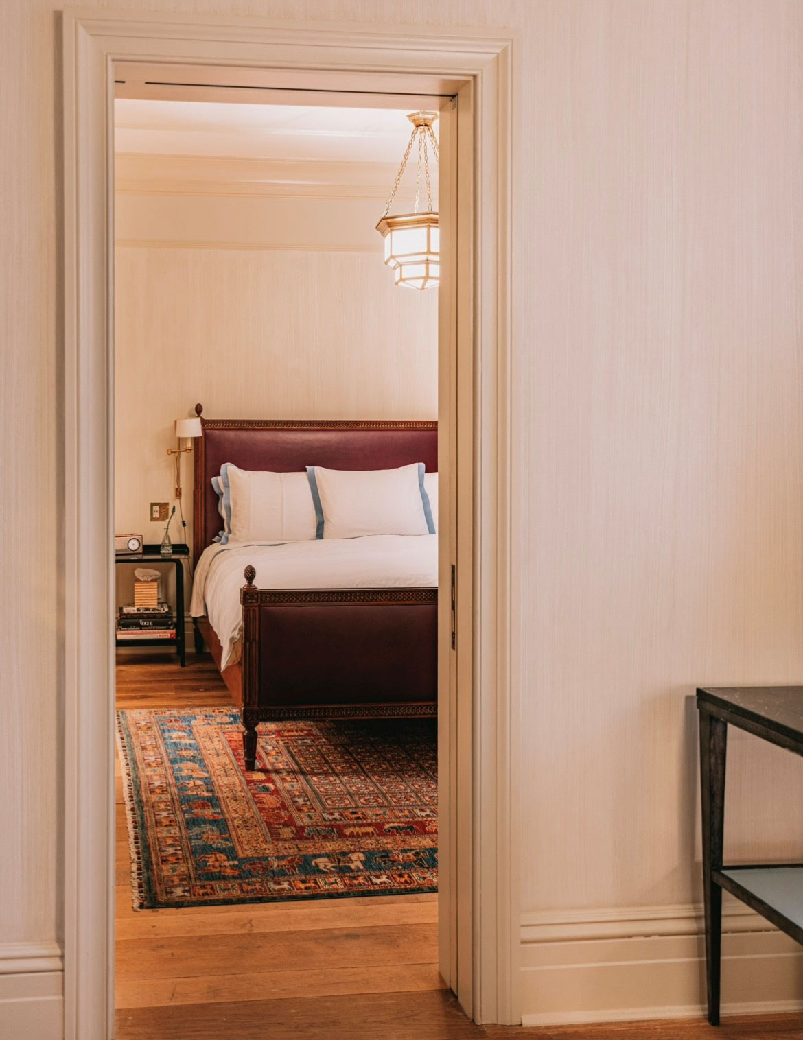 Looking into the bedroom through the doorway in the Corner Suite