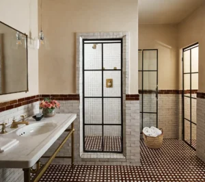 Deluxe King Bathroom with brown and white moroccan tile, a walk-in show and single sink vanity