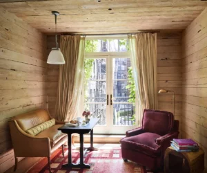 Superior King room wood paneling ceiling and walls seating area looking at the balcony doors