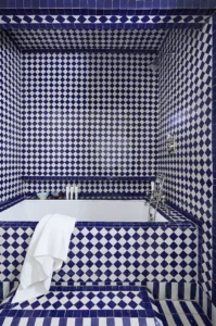 Blue and white tiled alcove soaking tub