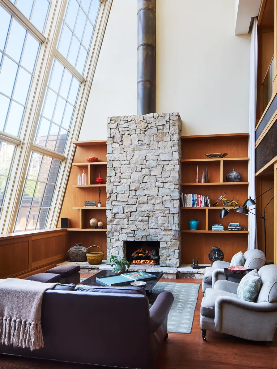 The seating area and fireplace under the natural light of the 30ft tall atelier windows