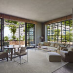 The Tribeca Penthouse's Living Room seating with round dinning table and doors open to the Outdoor Terrace.