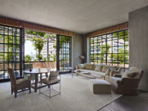 The Tribeca Penthouse's Living Room seating with round dinning table and doors open to the Outdoor Terrace.