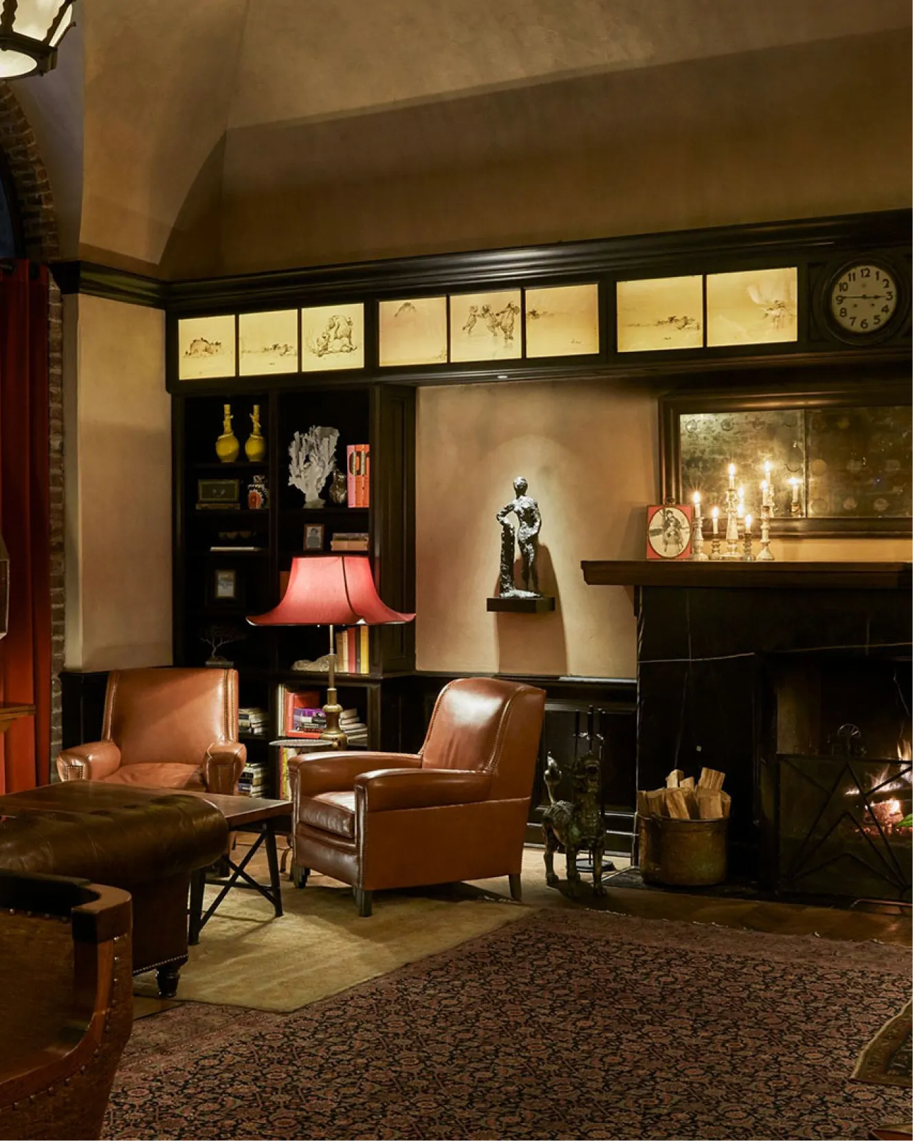 Two leather arm chairs next to the fireplace inside the drawing room at the greenwich hotel