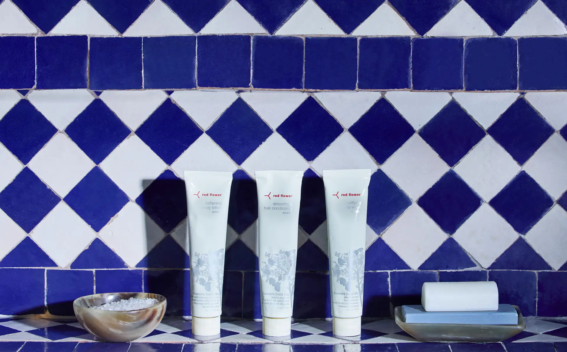 Bath products against a blue and white moroccan tile backdrop