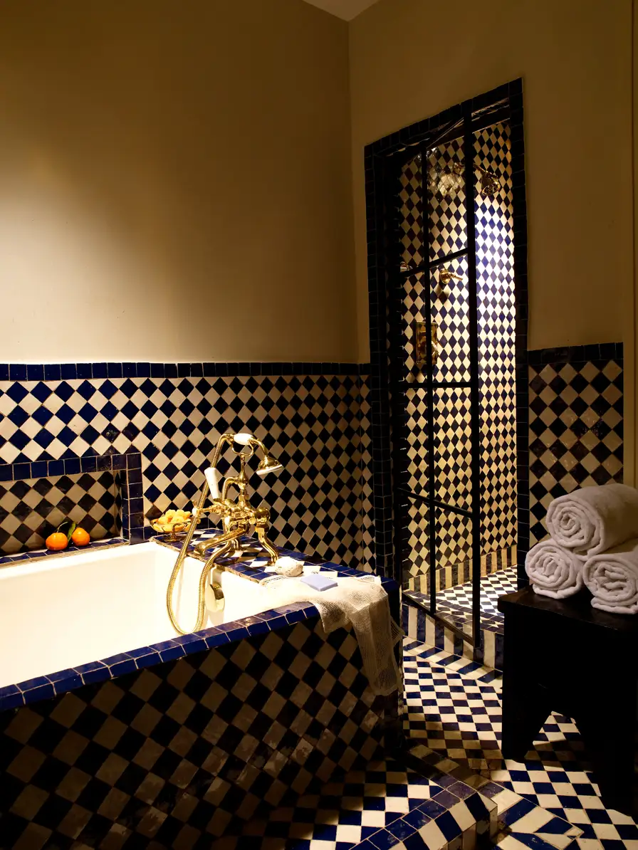 Walk-in shower door and soaking tub wrapped in blue and white tile