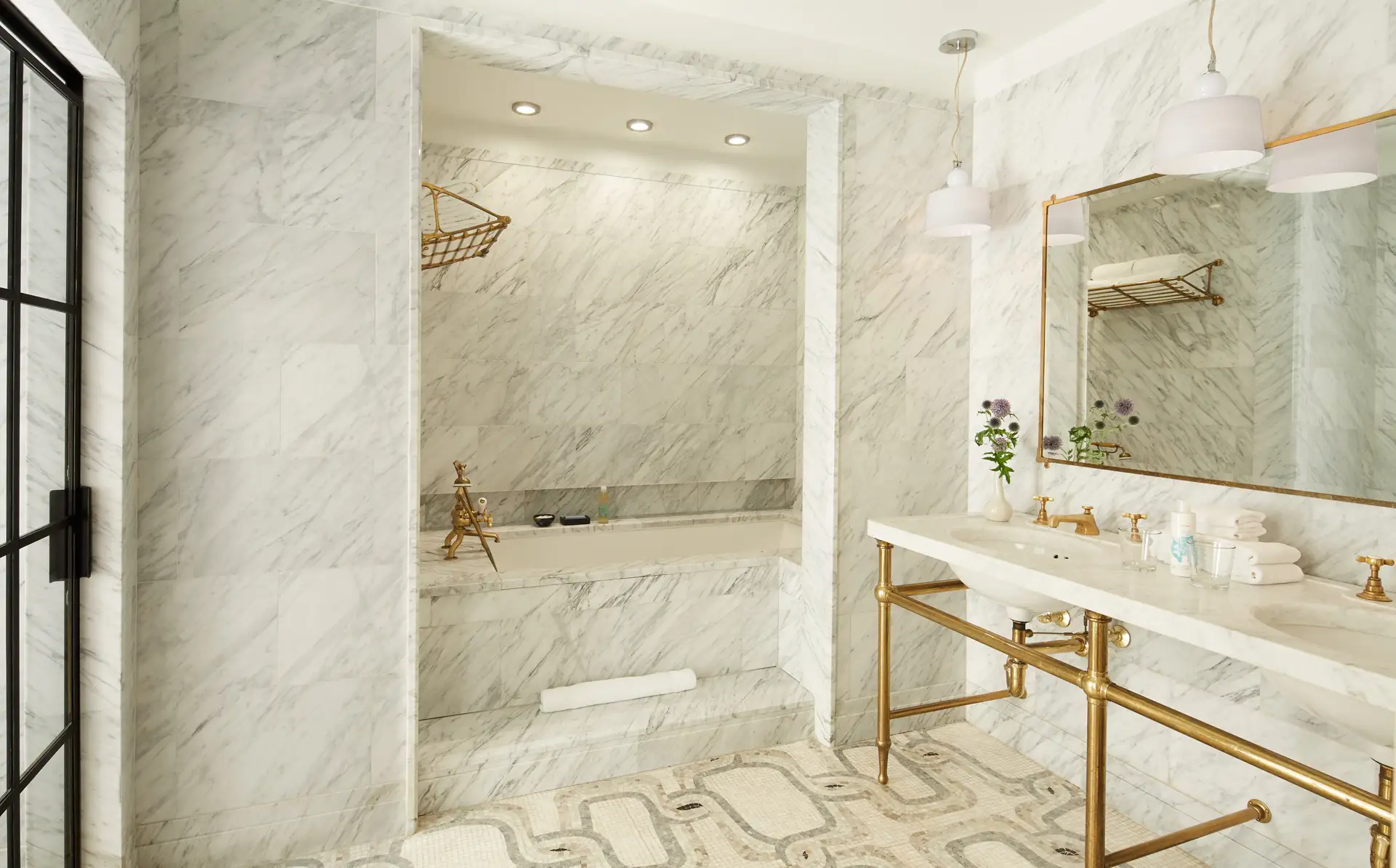 The Corner Suite bathroom with double sink vanity, marble alcove soaking tub and walk-in shower.