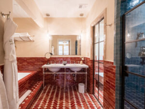 Wide view of the bathroom with a double sink