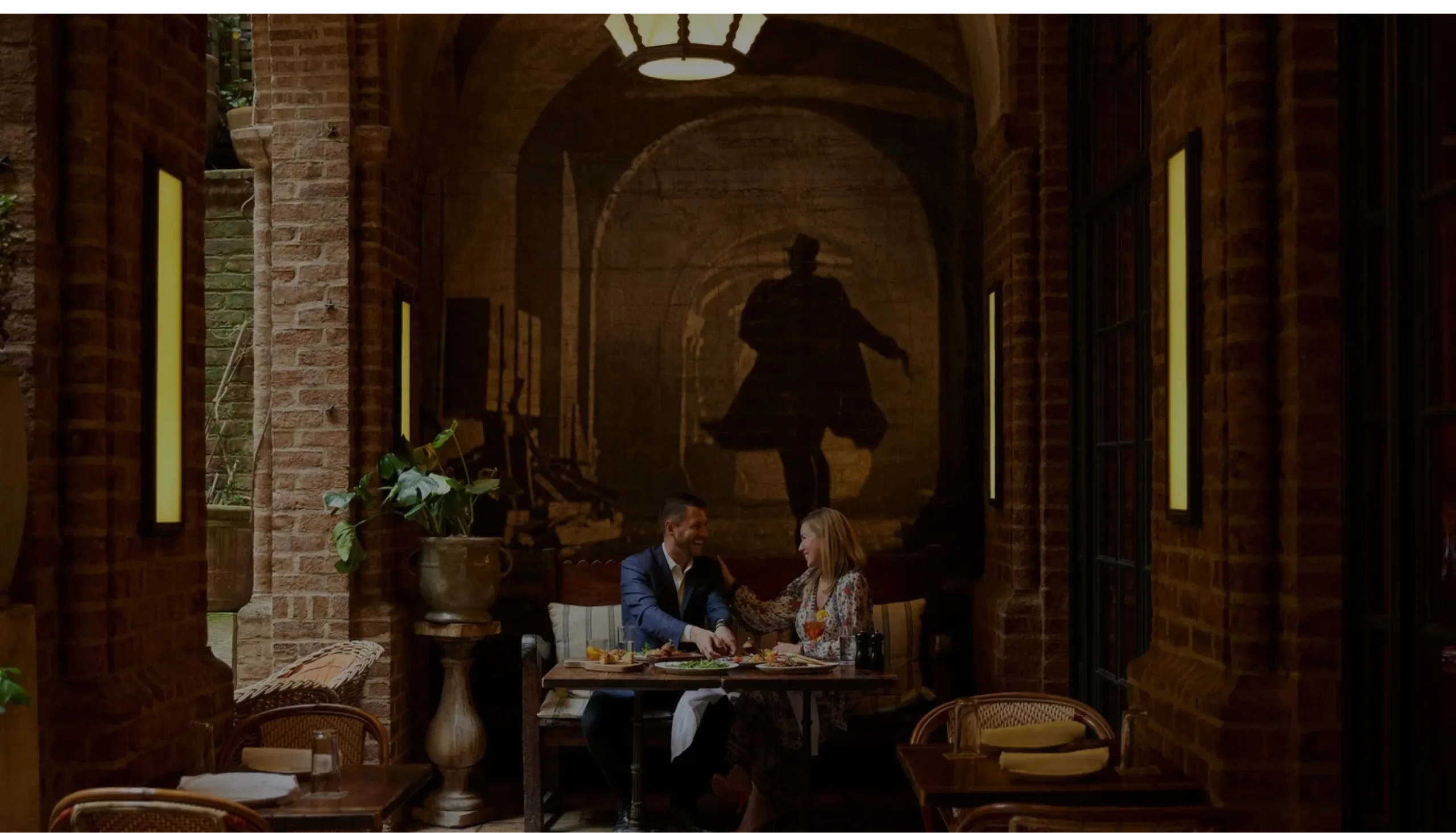 A couple having a dinner at the The Greenwich Hotel's Colonnade