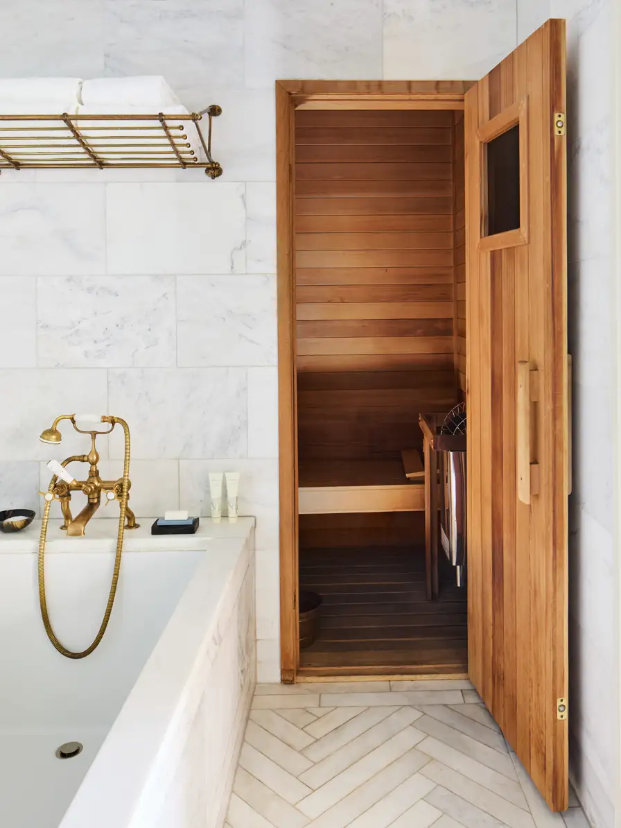 Looking past the bath tub into the private sauna inside the studio suite bathroom